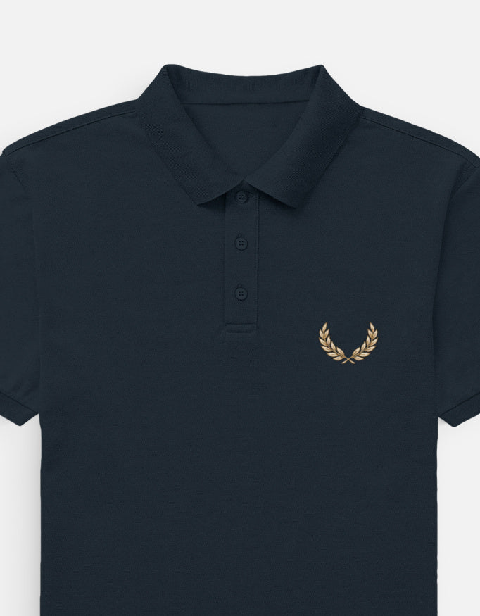A blue short-sleeve polo shirt with a small yellow and white embroidered graphic on the left chest, shown against a light gray background.