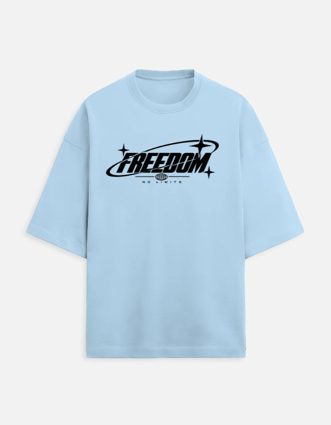 A light blue short-sleeve t-shirt with a black graphic on the chest reading 'FREEDOM' and 'NO LIMITS' underneath, displayed on a clean off-white background.
