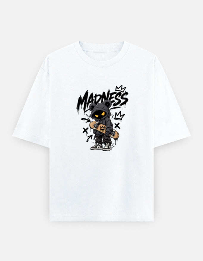 A white short-sleeve crewneck t-shirt featuring a central graphic of a cartoon character in a black hood with yellow eyes, holding a guitar, with the word 'MADNESS' written in a black graffiti-style font above.