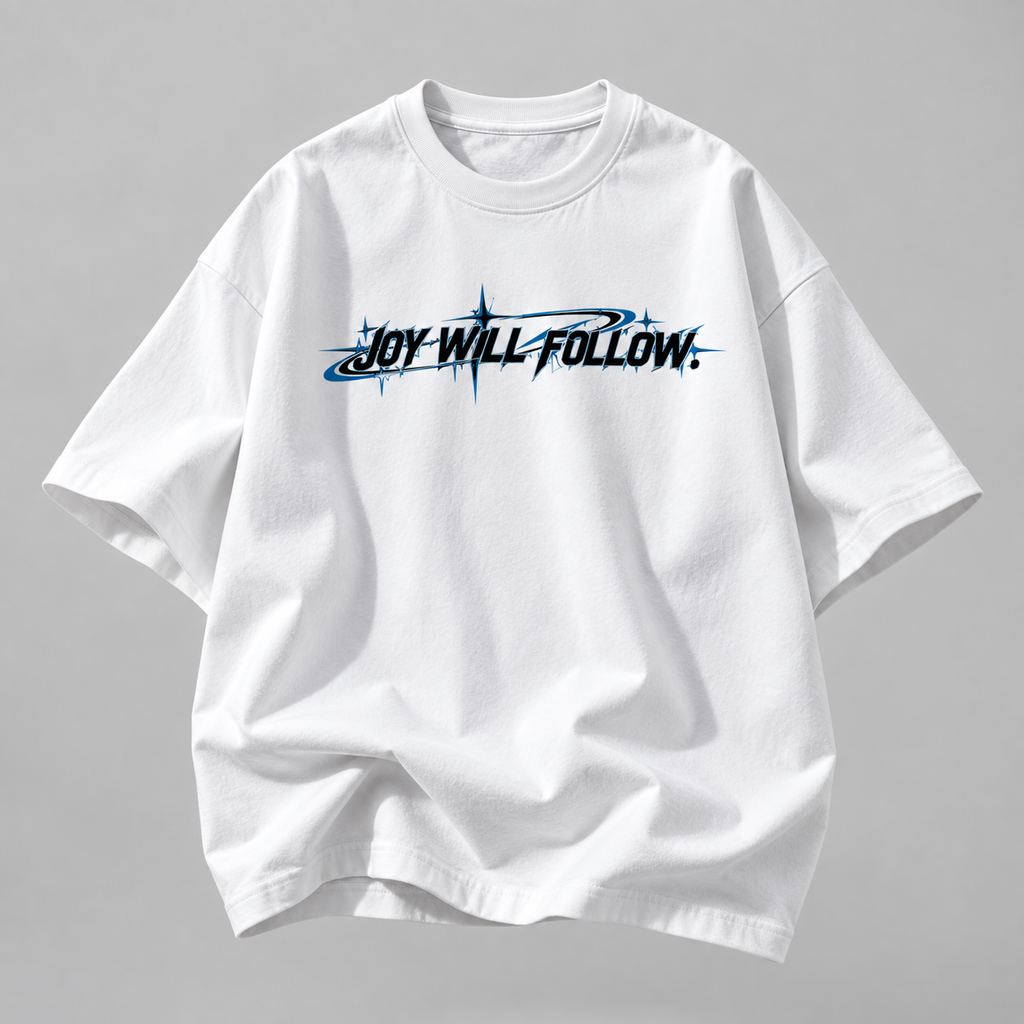 A white short-sleeve t-shirt with a black and blue graphic text reading 'JOY WILL FOLLOW.' across the chest, displayed on a neutral gray background.