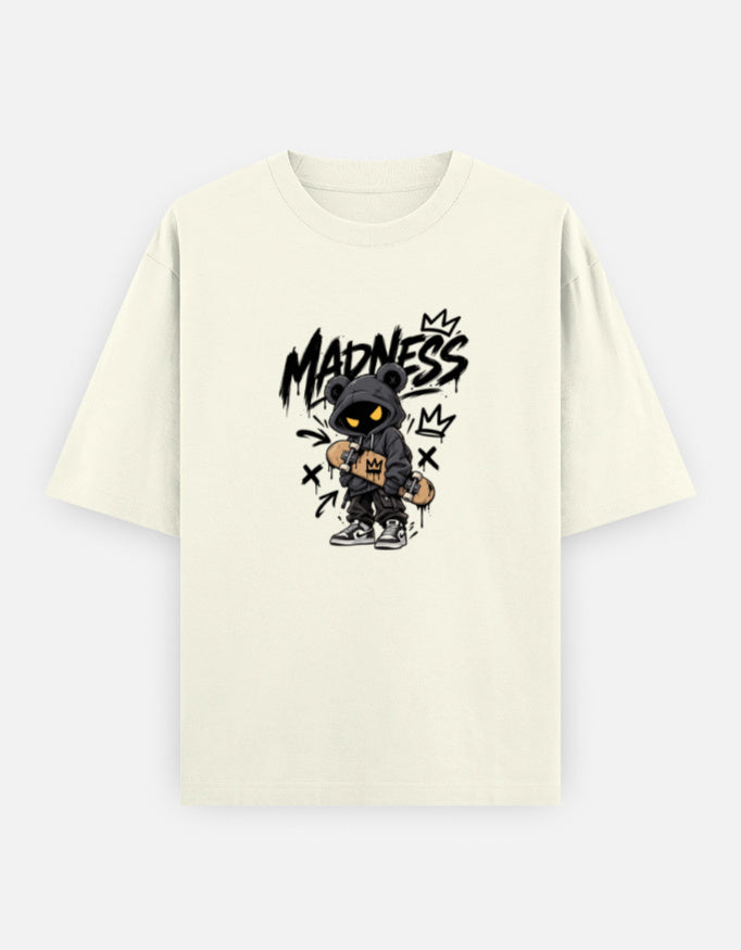 An off-white short-sleeve t-shirt with a central graphic of a cartoon character wearing a black hood and the word 'MADNESS' in black graffiti-style lettering.