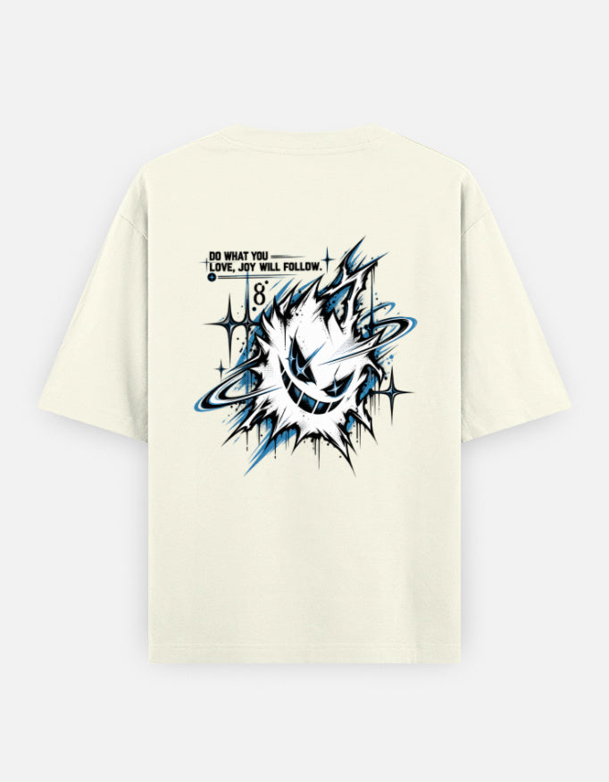 An off-white short-sleeve t-shirt with a large graphic print on the back. The graphic features a stylized, sharp-toothed creature in black, white, and blue, accompanied by the text 'I'D WHAT YOU.