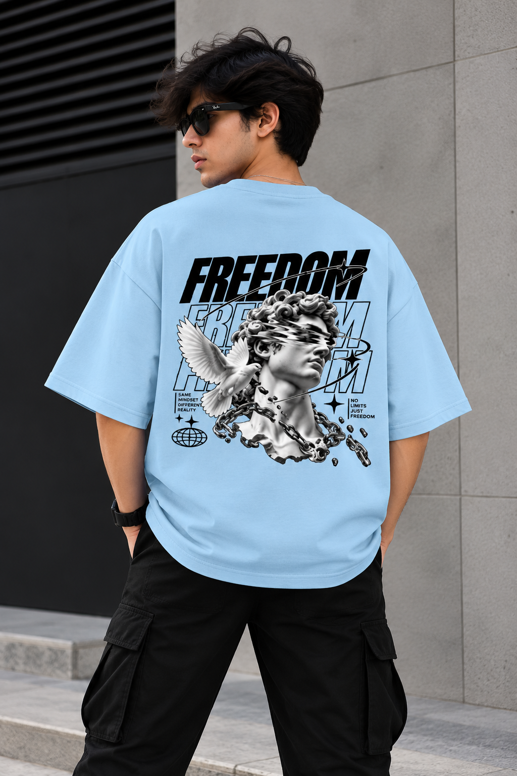 Model wearing blue oversized Freedom graphic streetwear t-shirt back 