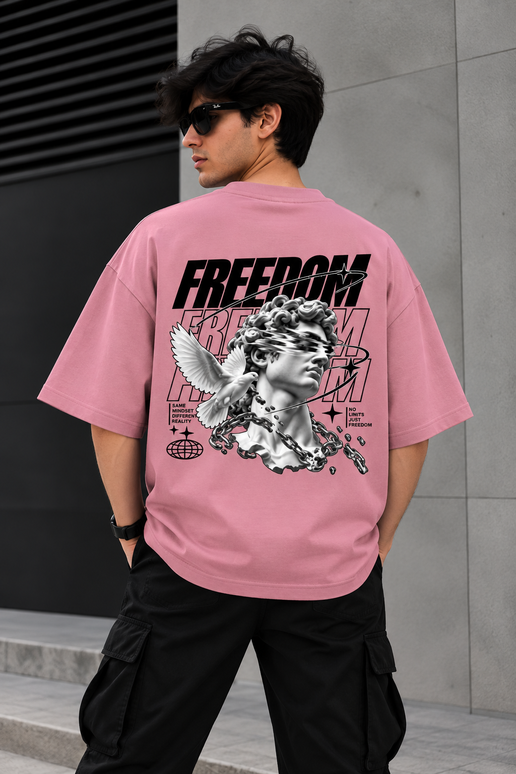 Model wearing light pink oversized Freedom graphic streetwear t-shirt back 
