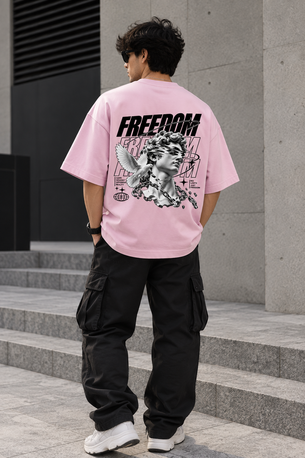 Model wearing pink oversized Freedom graphic streetwear t-shirt back