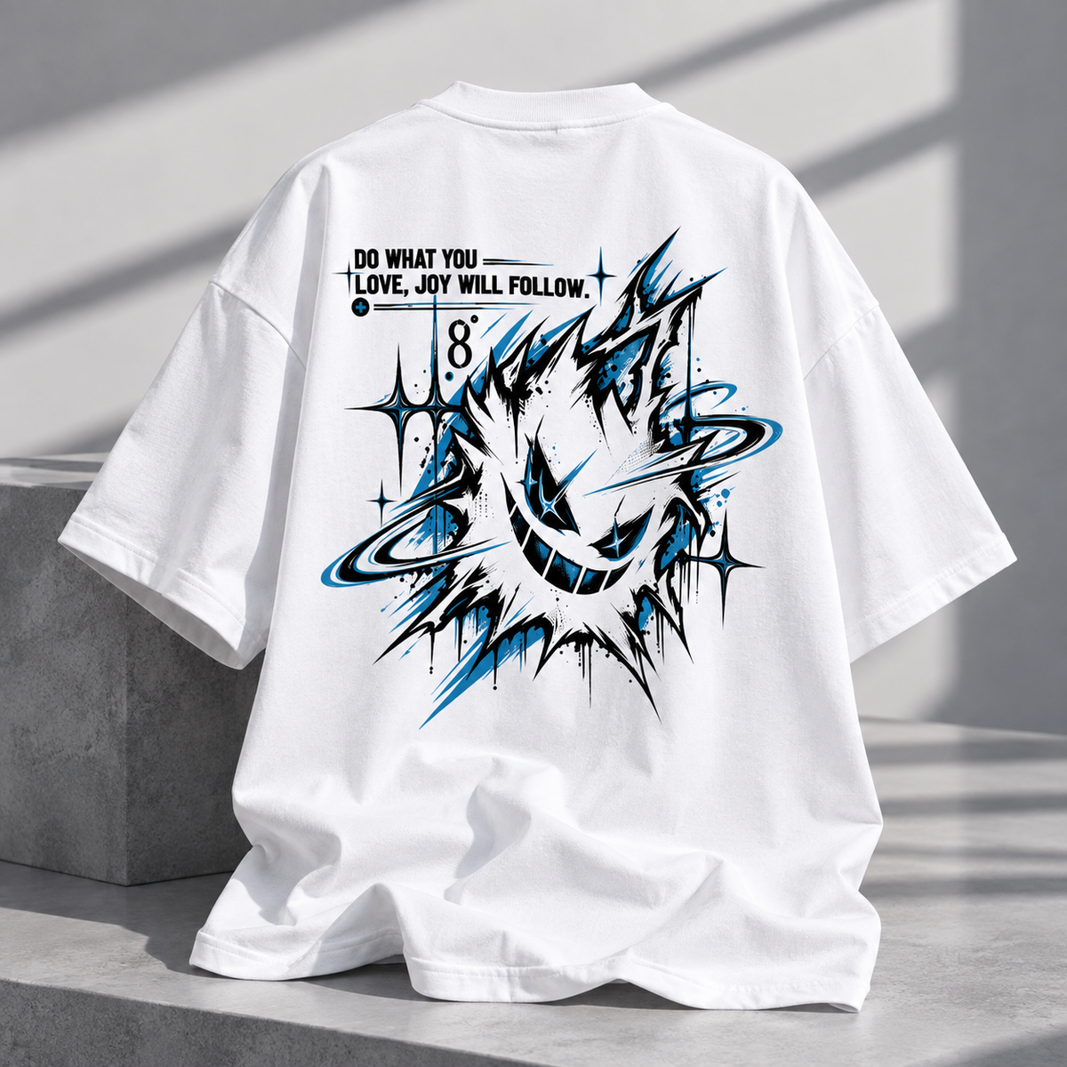 White oversized short-sleeve T-shirt shown from the back, featuring a large black and blue graffiti-style graphic with the text 'DO WHAT YOU LOVE, JOY WILL FOLLOW' and the number 8.